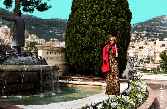Фотография рыжая девушка в леопардовом пальто у фонтана на фоне города 